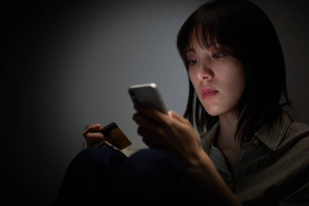 Japanese woman using smartphone in bed
